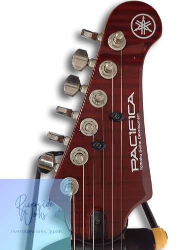 Yamaha Electric Guitar PAC612VIIFM with gold & black body, silver hardware, and “PACIFIC CAVES” logo on head.