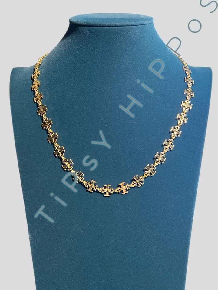 Collar de cadena con pieza de rompecabezas de oro Tory Burch con cierre ajustable y pouc de marca Foto 2 de 4