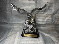 decorative silver-tone eagle statue/trophy with religious significance.