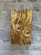 Wall sculpture with a wave relief and hand-laid gold leaf