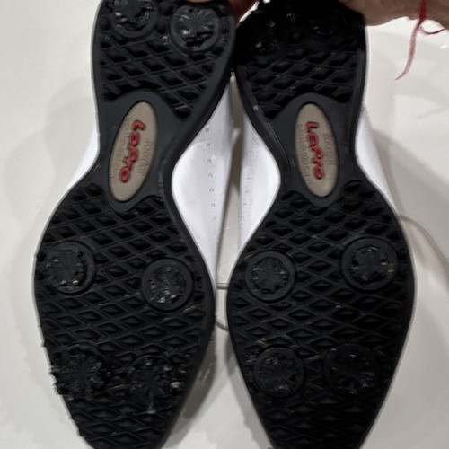 White leather FootJoy LoPro women’s golf shoes with black wingtip lace up, US 8M, shown from below with red logo and text.