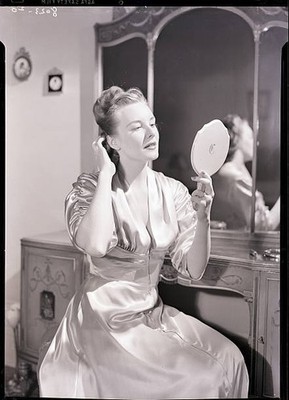 Barbara Lewis pats her hair as she primps in her bedroom She looks- Old Photo