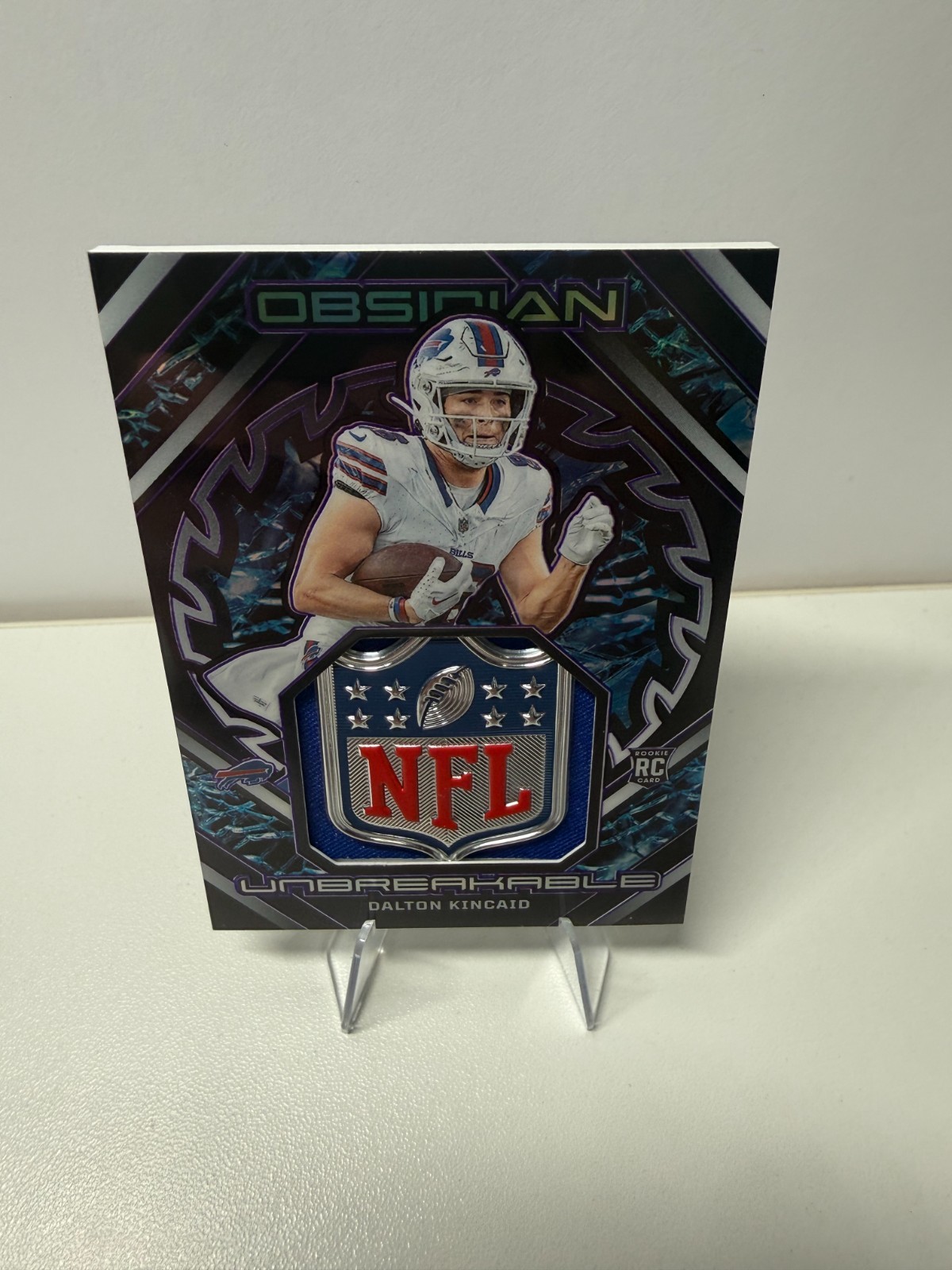 Dalton Kincaid 2023 Panini Obsidian Unbreakable Purple Etch NFL Shield RC /75