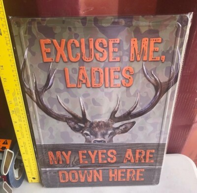 excuse me ladies my eyes are down here tin sign man