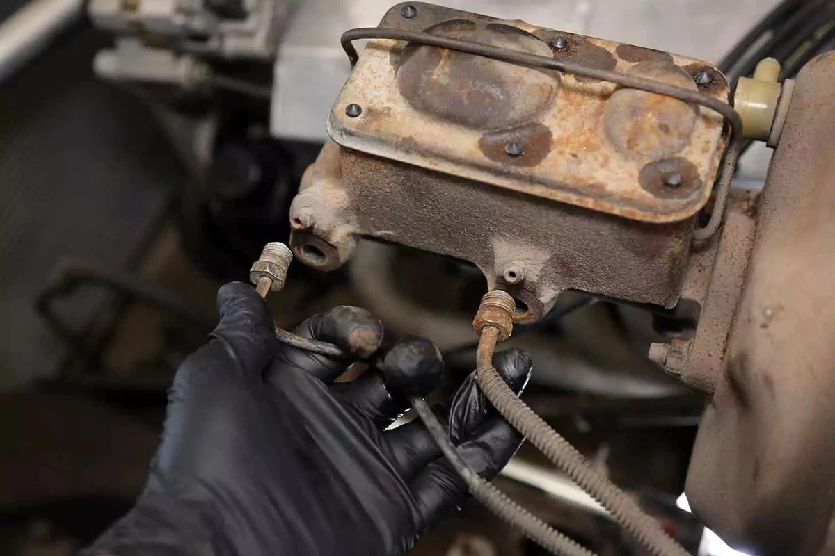 Removing the brake lines from the master cylinder.