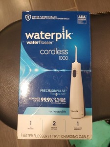 New Sealed Waterpik Cordless 1000 Rechargeable Water Flosser 1 tips 2 settings