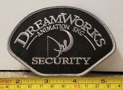 Dreamworks Animation Security Shoulder Patch.  4.75''×3.25''.  Grey on Black 