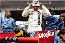 Carlos Pace dons his heat resistant balaclava while mechanics chec- Old Photo