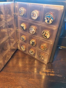 56 colorized Kennedy half dollars illustrating ww2 battles in album w/ history