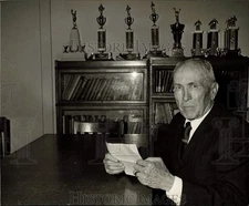 1968 Press Photo Man in room with trophies in background - hps10957