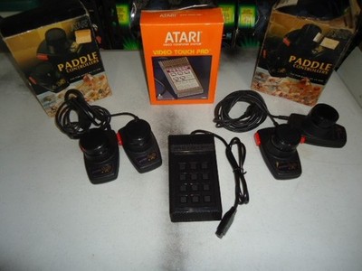 Lot of  Atari Paddle Controllers and One Video Touch Pad in Orig Boxes!