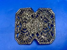 Beautiful A pique silver color - or real non magnetic - see though belt buckle