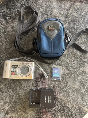 Panasonic Lumix DMC-ZS1 Camera 25 mm/12X, Case, Battery Charger & 1GB SD Card