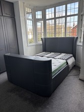 An Excellent Grey Leather Double Bed with Remote Control Concealed 32inch Tv.