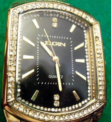 ELGIN BLACK FACE ALL GOLD TONE WATCH WITH FAUX DIAMONDS AROUND FACE AND BANDS