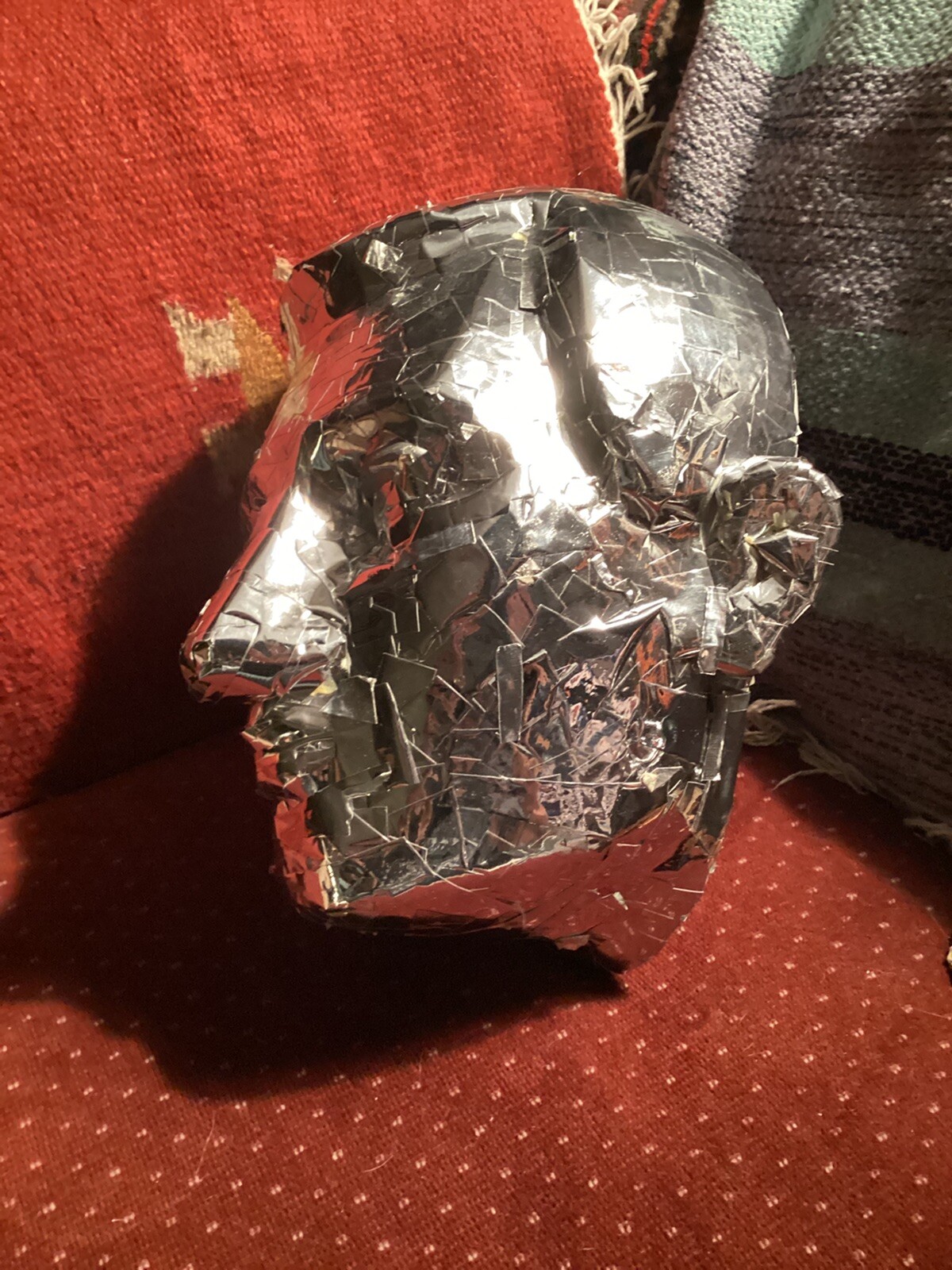 tinfoil covered man’s face mask, lifesized at 12” high x 10” wide x 10