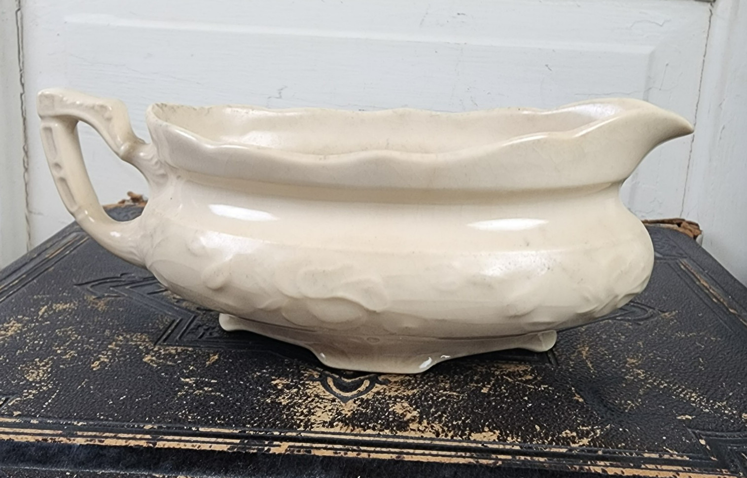 White ironstone gravy boat with visible age crazing.