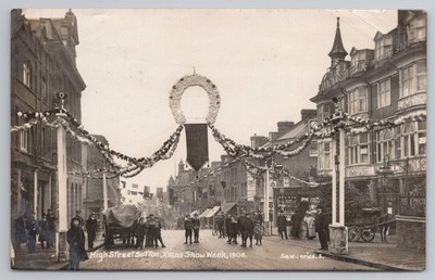 RPPC High Street Sutton Xmas Show Week 1908, floral arch & crowd