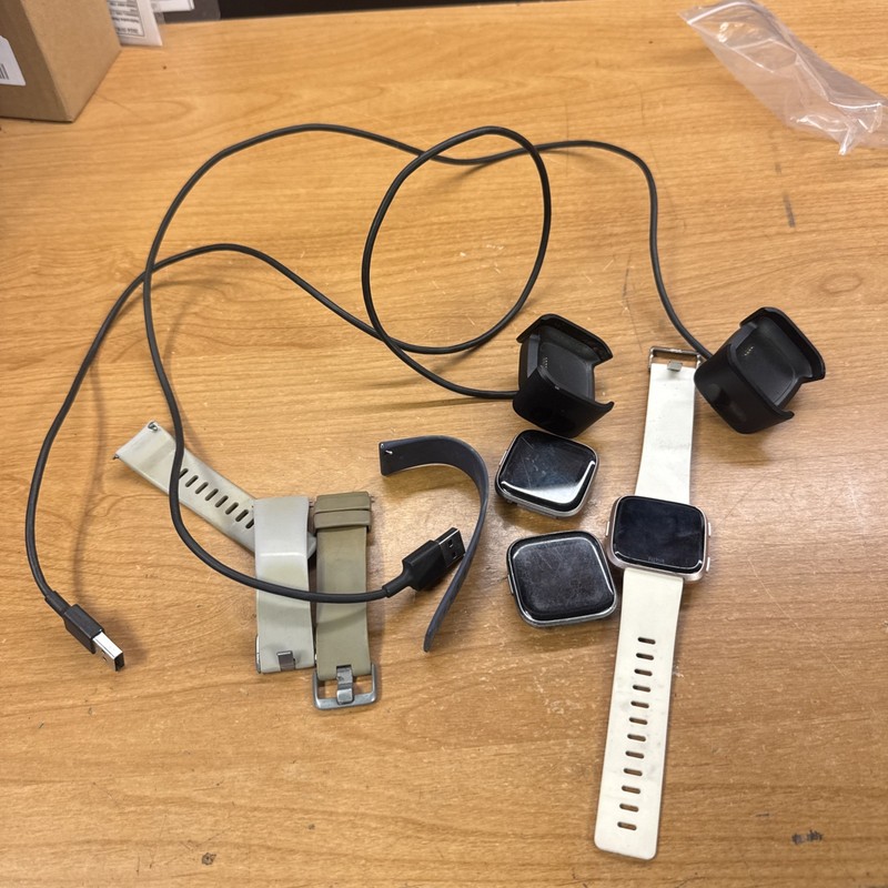 3 Fitbit Versa with 2 chargers & Other Fitbit  (FOR PARTS / REPAIR)