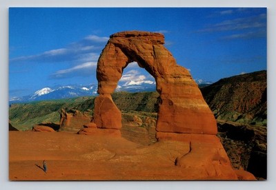 Delicate Arch Natural Stone Formation with Snow-Capped Mountains in Utah