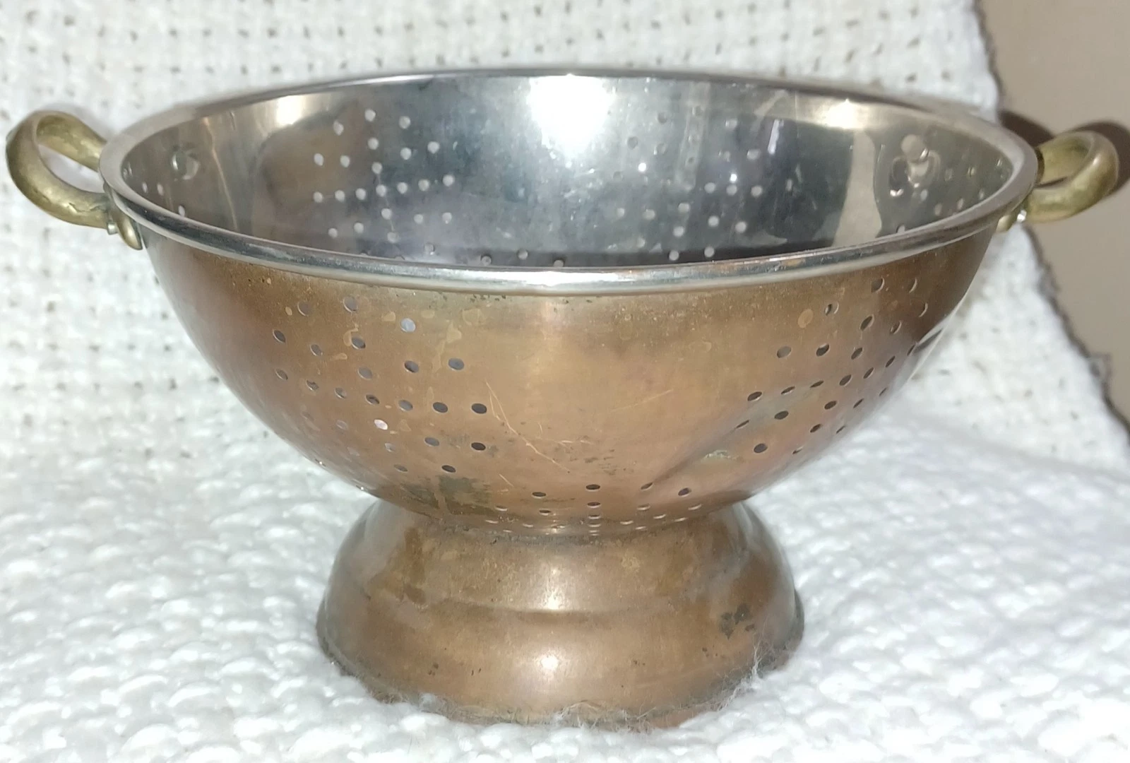 Vintage 9-inch colander with a copper exterior.