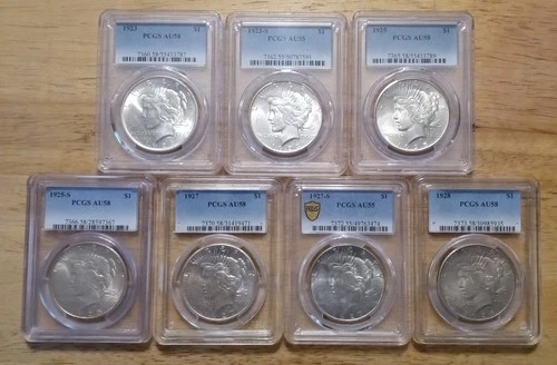 LOT OF SEVEN PEACE DOLLARS (PCGS AU) including the low mintage 1928