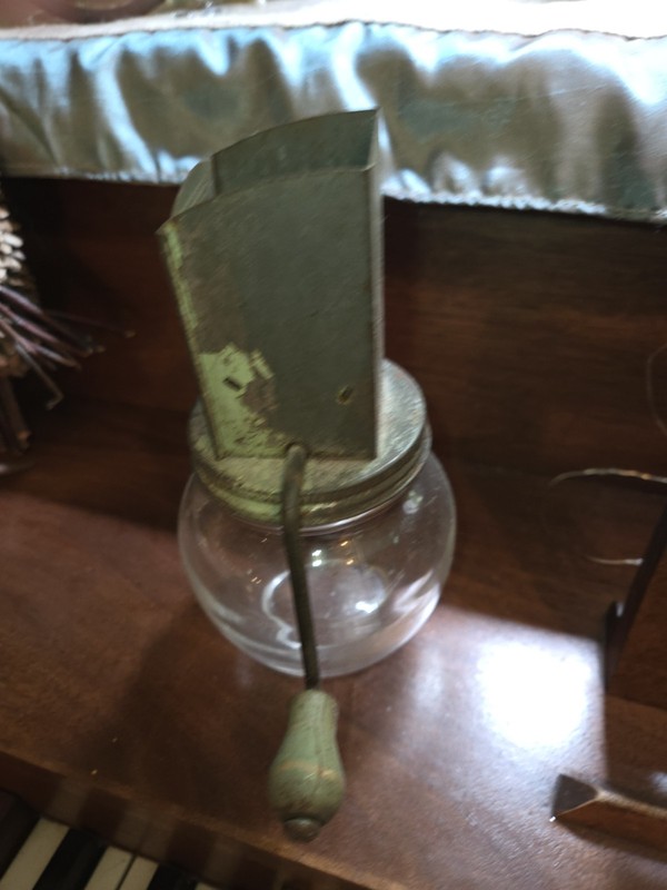 This vintage Androck nut chopper features a green metal top and a glass jar...