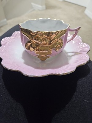 ANTIQUE PINK LUSTERWARE TEACUP AND SAUCER W/GOLD FLORAL EMBELLISHMENTS