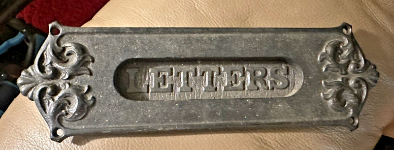 Antique cast iron door mail slot with embossed 'LETTERS' and ornate scrollwork