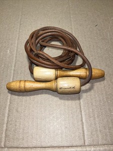 vintage Muhammad Ali Rope-a-Dope jump rope with wooden handles and leather rope