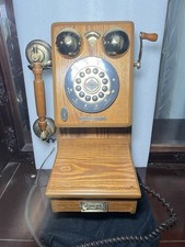 This is a Thomas Collector's Edition 1927 wooden wall telephone