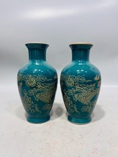A pair of antique gold mouth carved dragon and phoenix vases