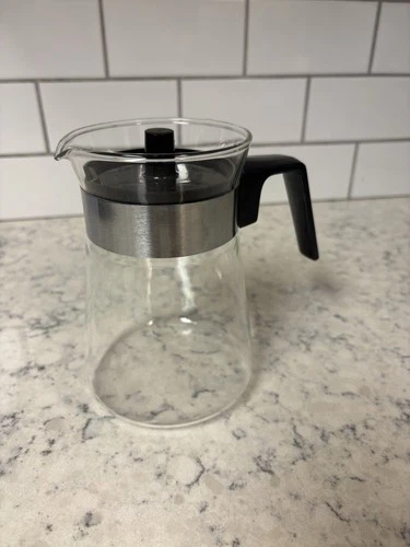 Vintage Pyrex glass “ Maple Syrup” carafe with black handle and lid.