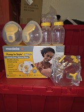 Medela pump in style pump with extra breast cups, bottles, and tubing. New