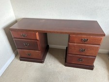 Traditional mahogany double-pedestal desk with brass hardware.