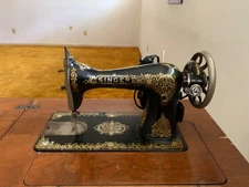 vintage singer sewing machine in wood cabinet