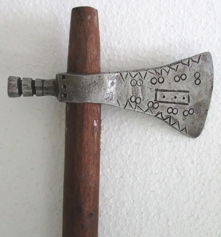 An antique axe with fine decorative detailing on both sides — the kind of rare wall-worthy piece that turns a workshop or den into a museum.