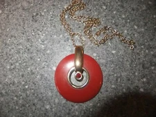 LARGE ORANGE PLASTIC DISC NECKLACE WITH GILT DETAILING WITH A DESIGNER TAG