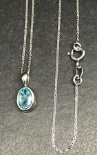 9ct white gold blue topaz pendant oval 7 x 5mm. 18” chain. New. Gift box.