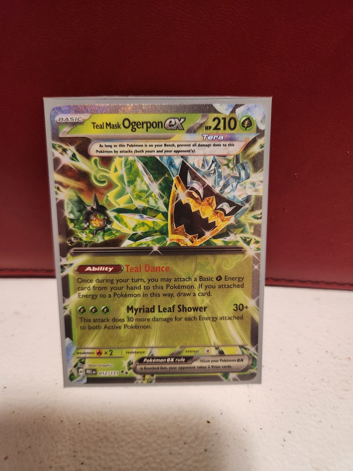 TEAL MASK OGERPON EX 12/131 DOUBLE RARE, COMES SLEEVED NEW IN MINT CONDITION