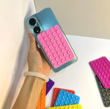 Black /pink suction cup phone case stand, double-sided silicone, 1 piece.