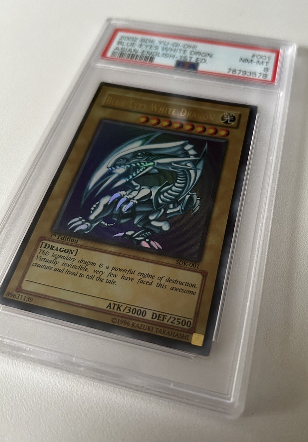 Yugioh Blue Eyes White Dragon 1st Edition SDK001 PSA 8 Mint holo Bleed