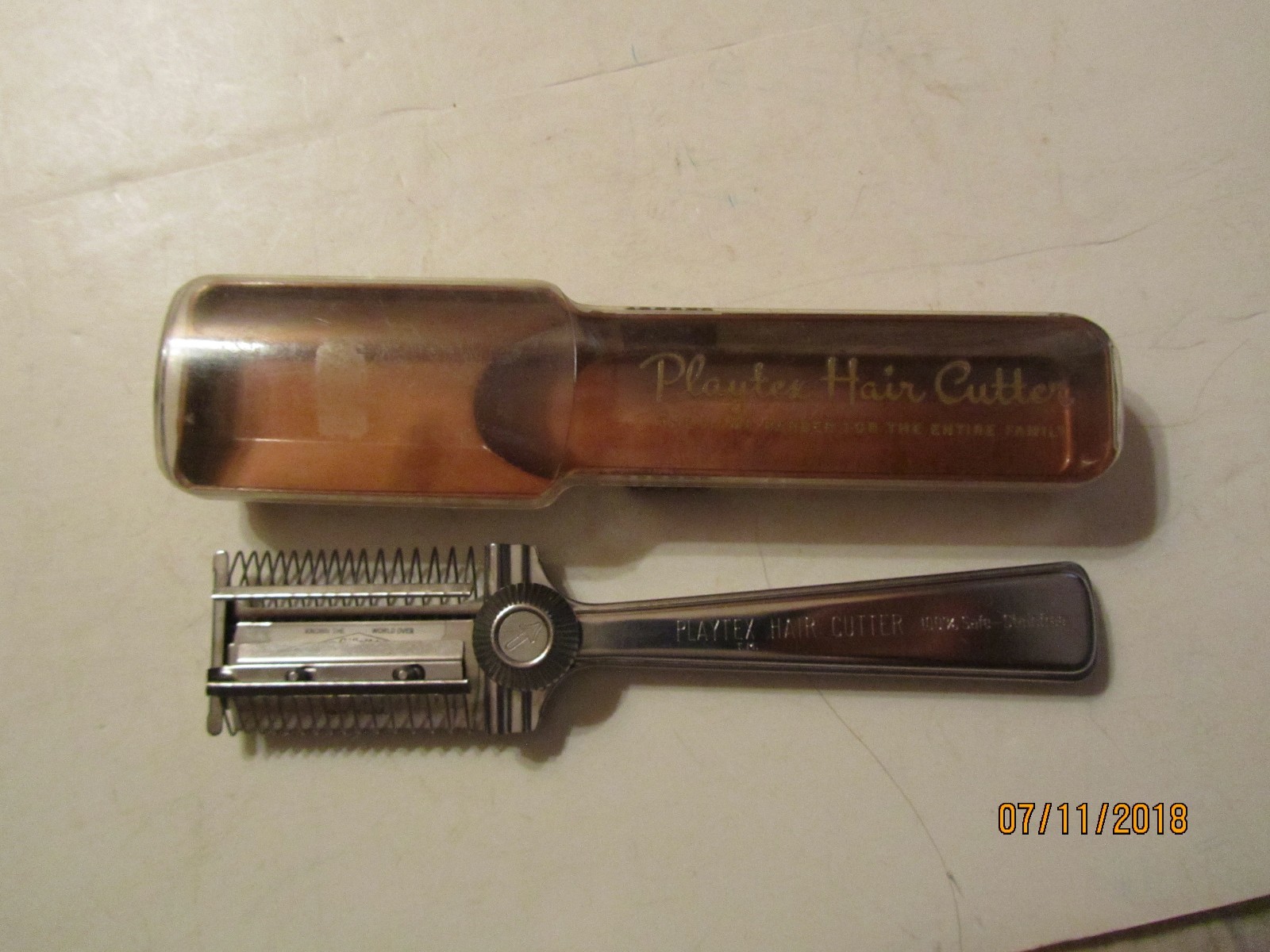 Vintage brown Playtex Hair Cutter with silver handle in clear case, labeled “Made in U.S.A.”