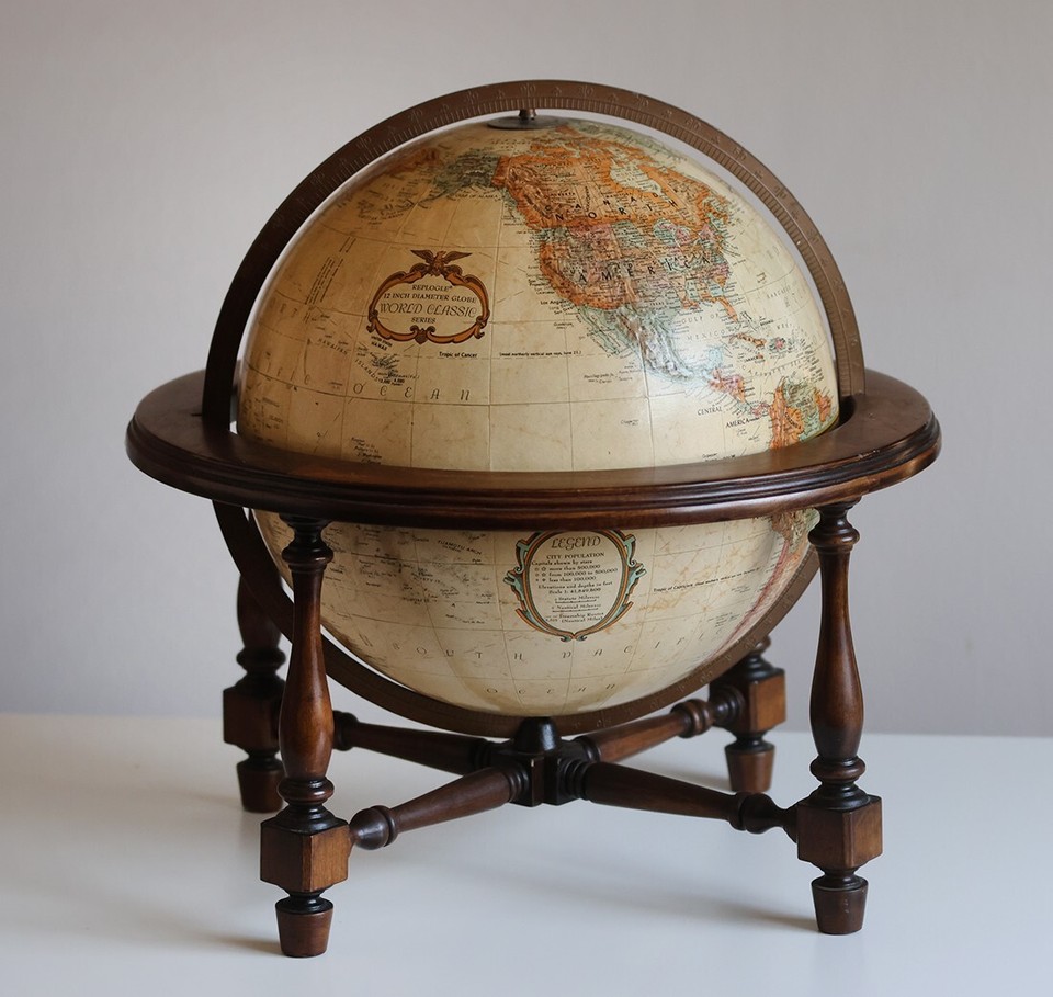A genuinely handsome vintage Replogle 12" globe on a four-legged walnut base — the kind of desk piece that makes a whole room look smarter.