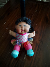 Soft Body Baby Girl Doll Blue Eyes Light Complexion Black Curly Hair Tutu