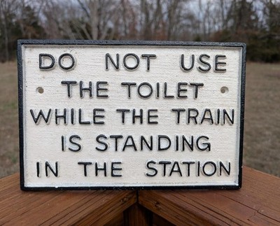 CAST IRON DO NOT USE THE TOILET WHILE TRAIN IS IN STATION RAILROAD SIGN PLAQUE!