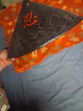 image shows a black conical hat, often referred to as a Samurai hat orRonin hat