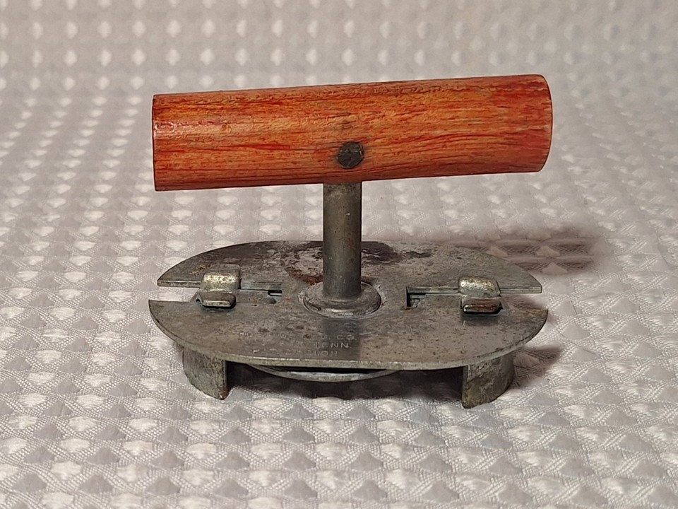 A Tennessee-made Hoskins jar opener with a fire-engine-red wood handle — the kind of sturdy, handsome American-made tool that looks great on a hook and actually gets used.