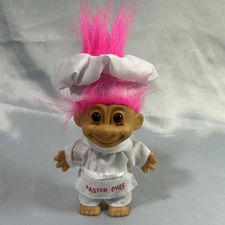 Vintage Troll Doll 4 inches tall with bright pink hair and "master chef" outfit