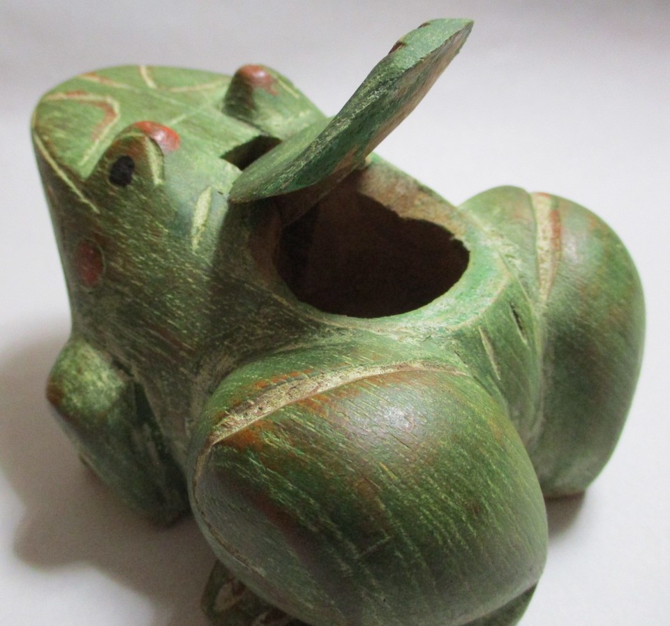 A hand-carved wooden folk art frog with a secret compartment — the craftsmanship, whimsy, and hidden-storage element make this a genuinely delightful one-of-a-kind find.